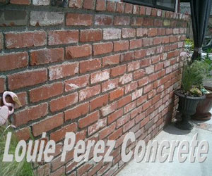 A Brick Wall Next to Garden Pots